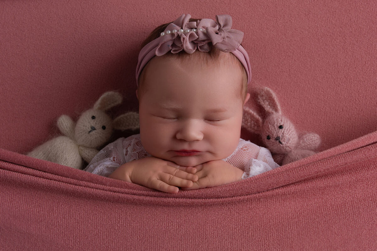 gentle sleep training with newborn girl sleeping with bunnies