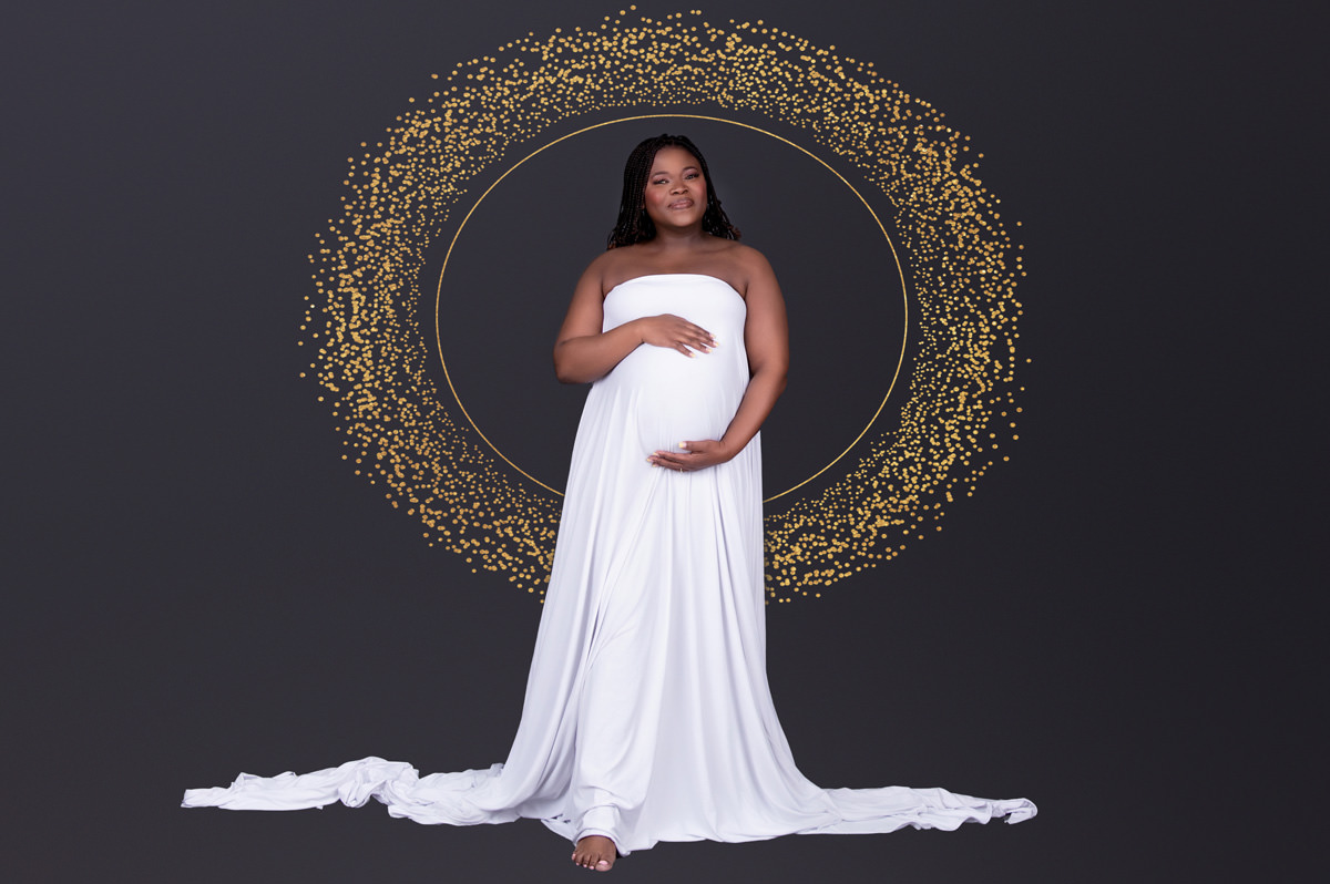 Studio maternity photo of a mom-to-be in a white gown with a golden halo backdrop, symbolising nurturing care and Pretoria North birth support options.