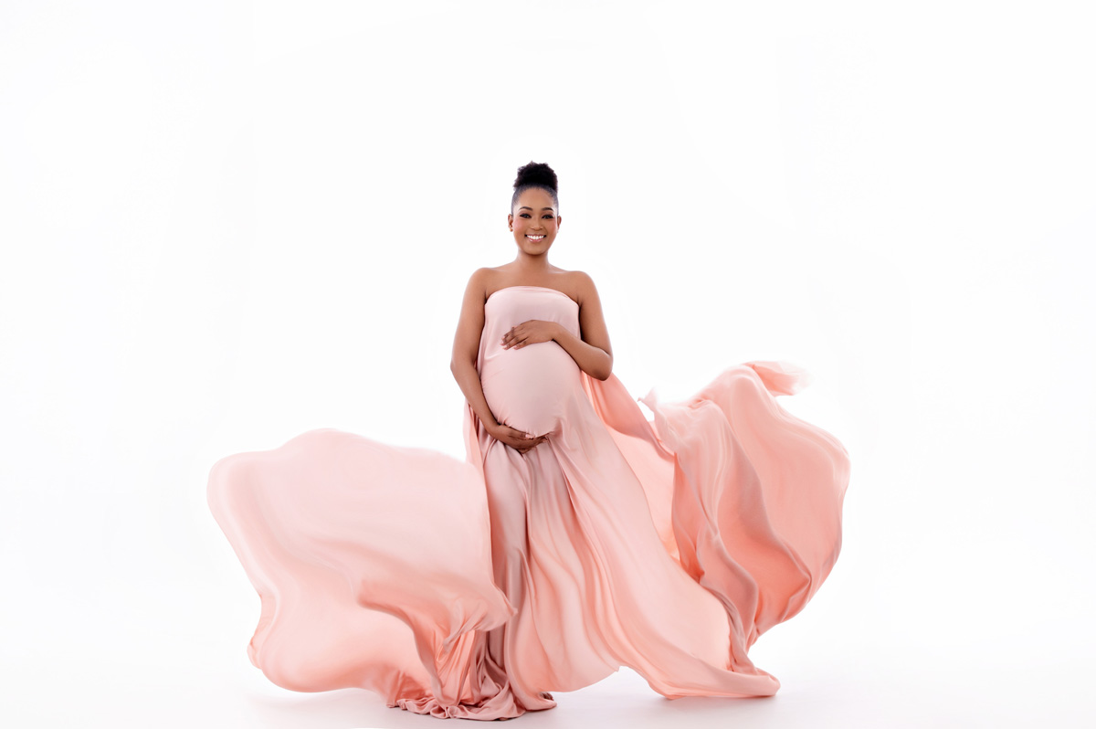 Fine-art maternity portrait in soft pink flowing gown during studio session – Pretoria maternity photography.