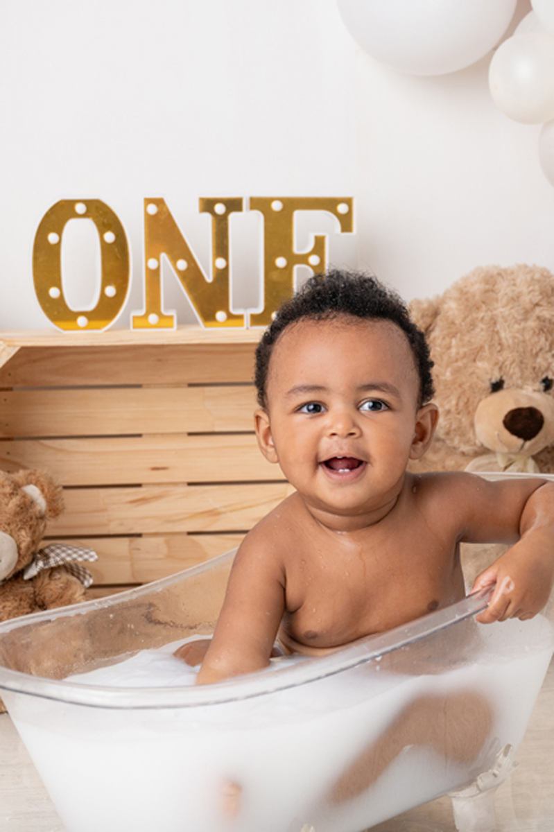 baby in milk bath in photo studio