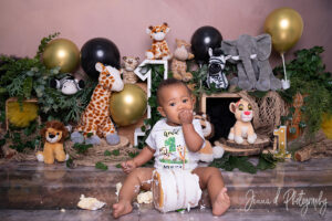 cute little baby boy eating his birthday cake