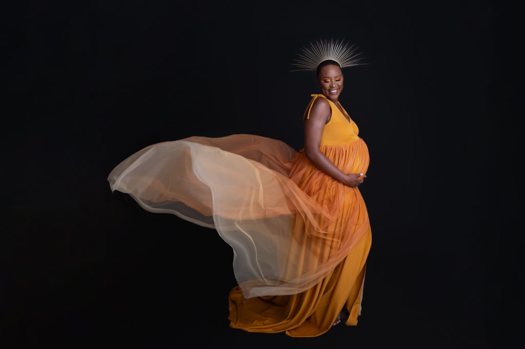 pregnant mommy in mustard coloured maternity dress, studio photoshoot