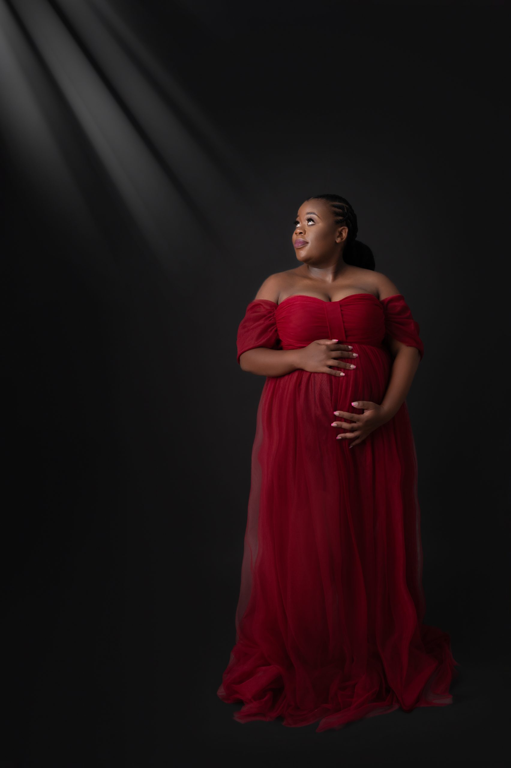 Pregnant lady dressed in beautifull burgundy maternity dress