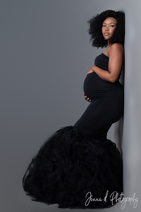 grey backdrop mom with big black maternity dress