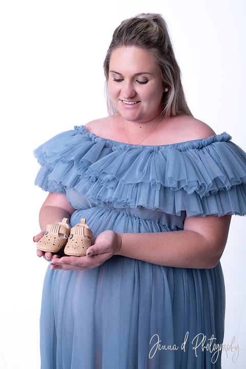 mommy to be in studio grey backdrop blue dress