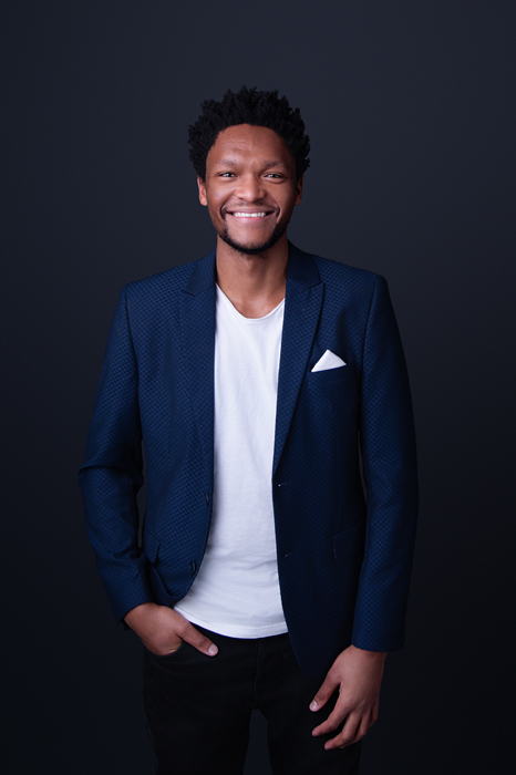 Man in studio against grey backdrop, headshot business images