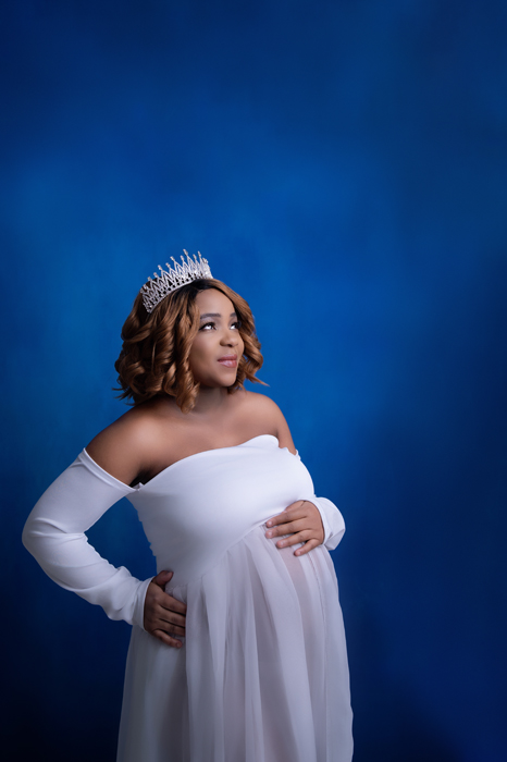 Maternity in studio blue backdrop