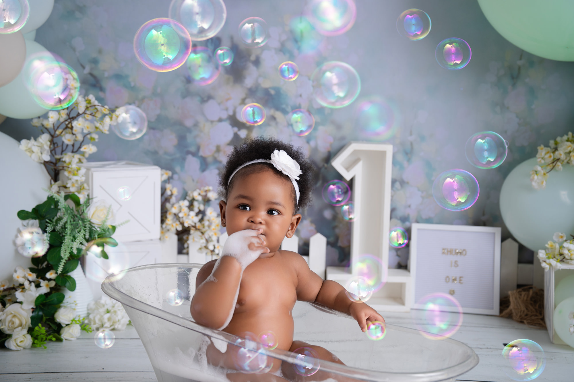 Bubble bath photo after cake smash with baby and bubbles in studio