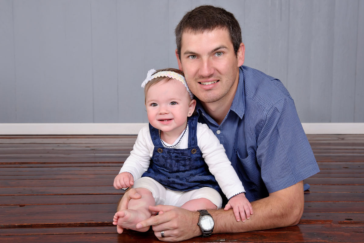 Father bonding with baby during studio photoshoot, reflecting family values