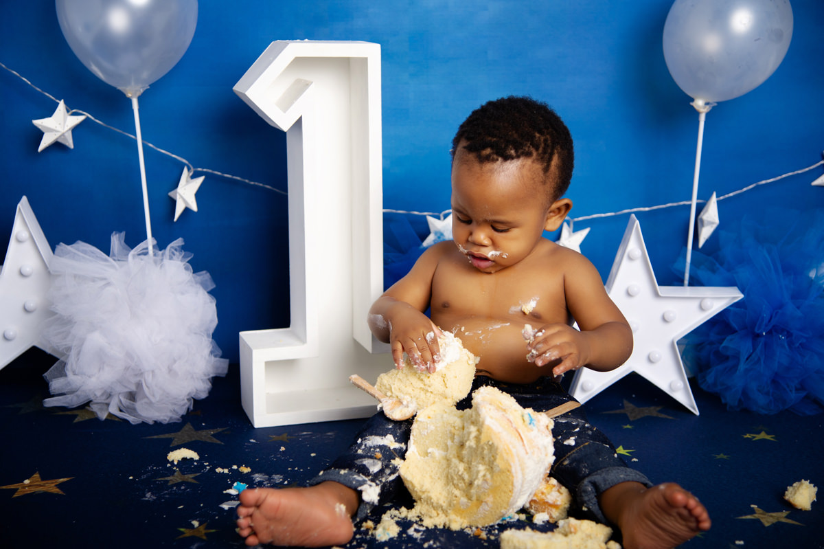Cake smash moment with baby boy enjoying birthday cake in studio – 1st birthday cake baker centurion.