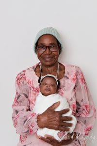 Three generations together — proud grandmothers holding baby Nomthandazo Zileni during family newborn session.