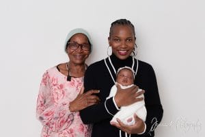 Three generations together — proud grandmothers holding baby Nomthandazo Zileni during family newborn session.