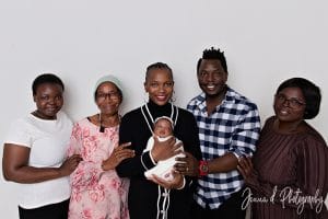 Three generations together — proud grandmothers holding baby Nomthandazo Zileni during family newborn session.