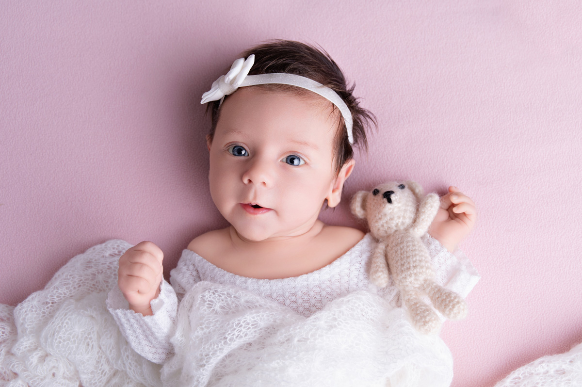 baby on pink fabric wrapped ready for baby clinic day