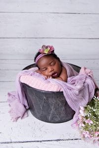 sleepy newborn in bucket