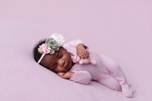 newborn on pink fabric