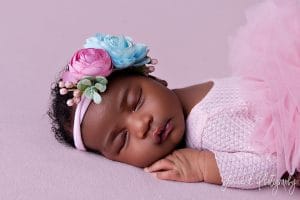newborn on pink fabric