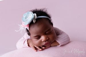 sleepy newborn on pink fabric b