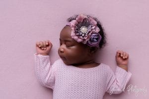 newborn on pink fabric