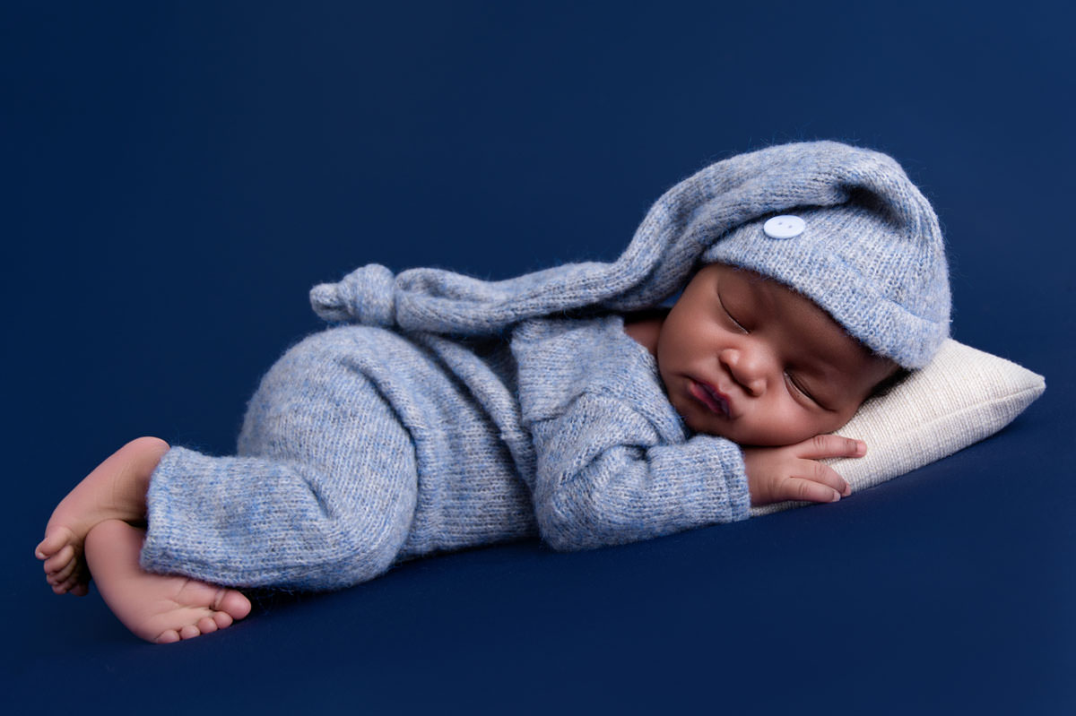 Newborn baby resting peacefully in studio setting, representing the early postpartum stage often explored in baby blues vs postpartum depression.