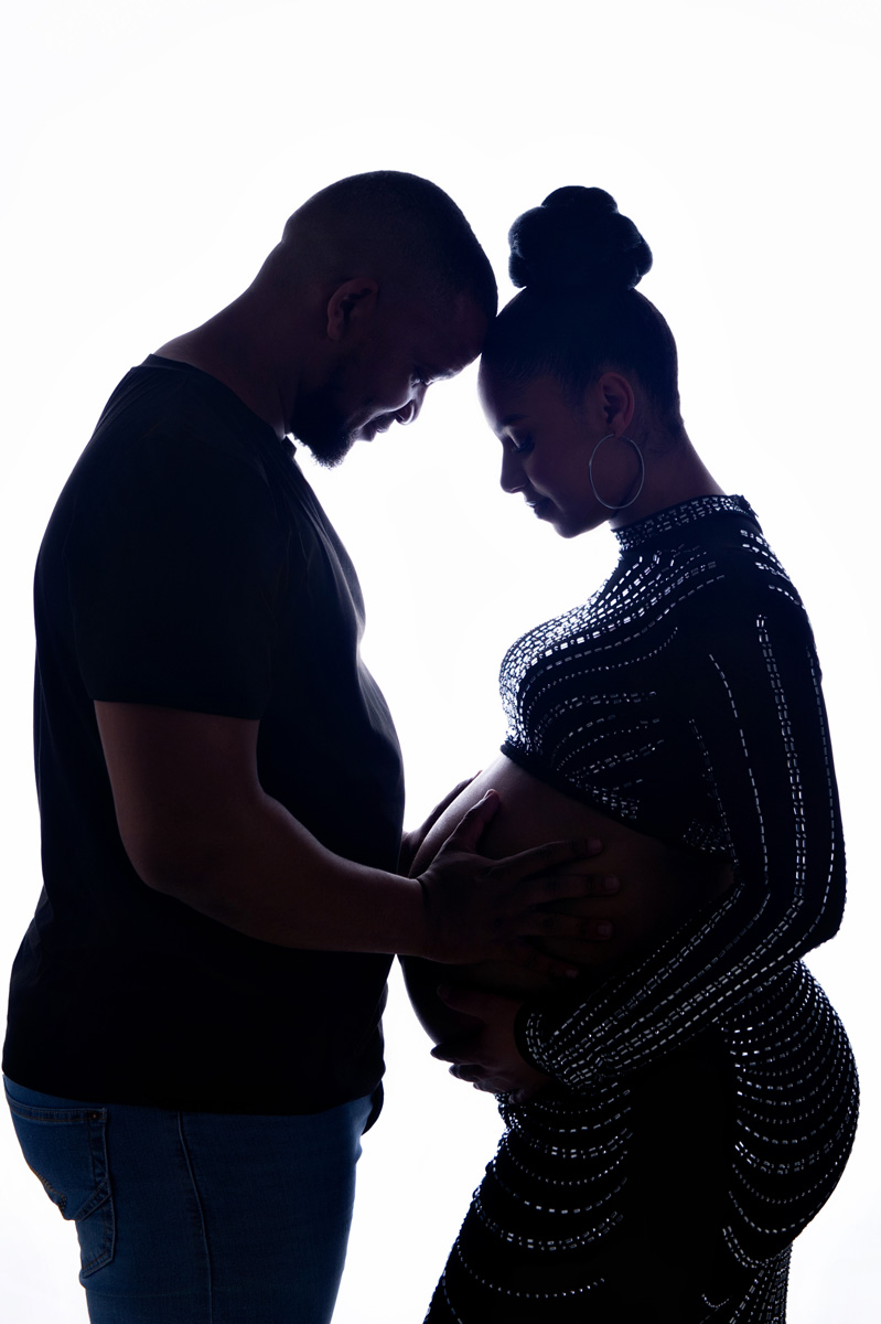 Romantic maternity silhouette of expecting couple touching belly during studio session – Pretoria maternity photoshoot.