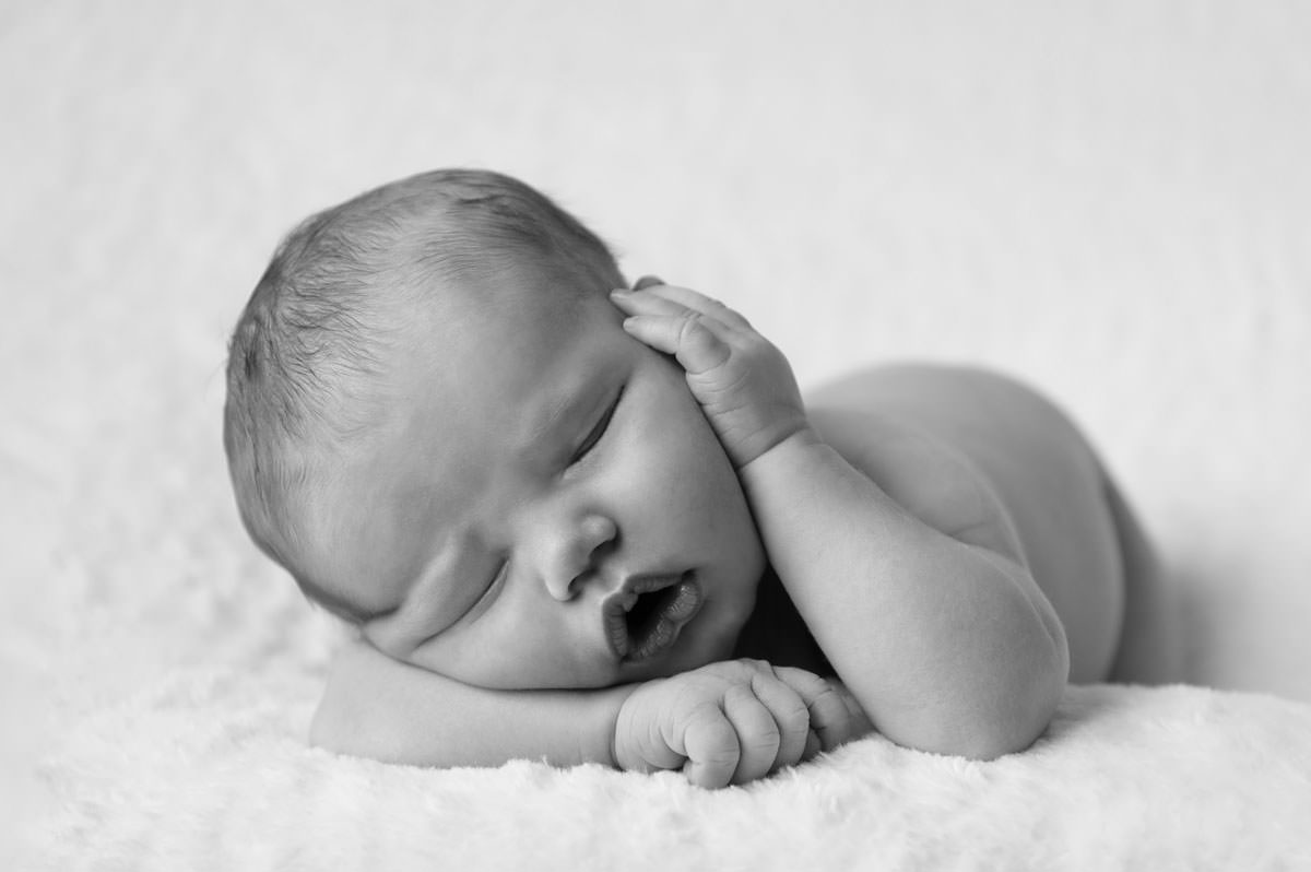Sleeping newborn baby girl on soft pink backdrop, reflecting early development supported by the best baby sensory classes in Pretoria East.