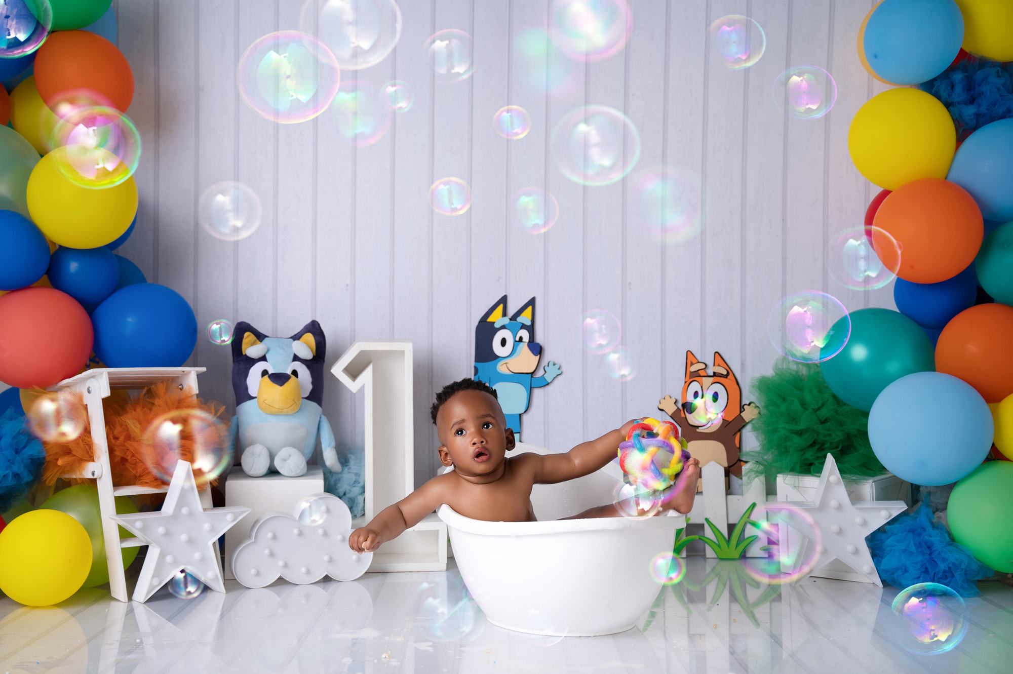 boy enjoying a swim in a little white bath