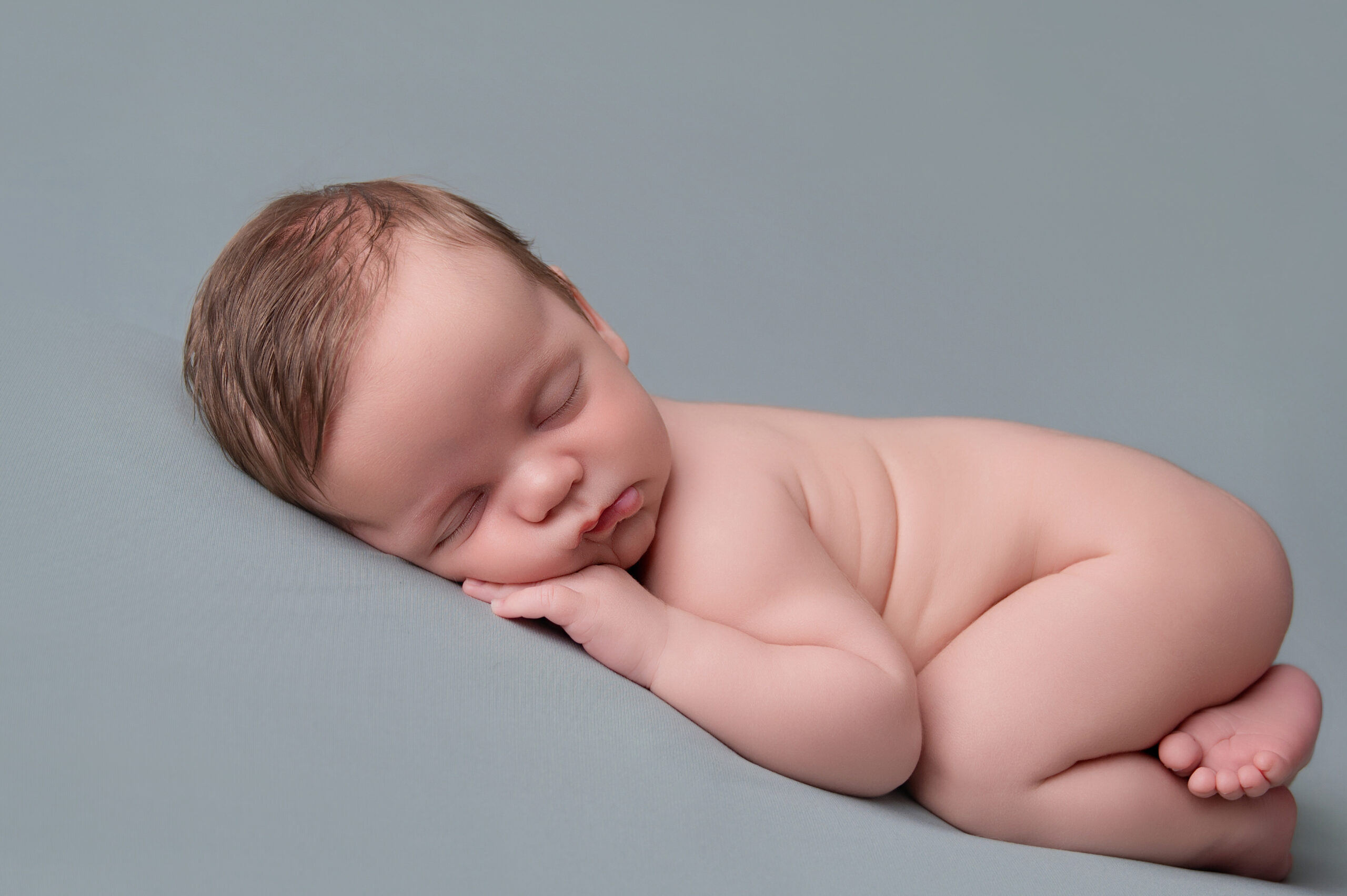baby boy on green newborn backdrop i n pretoria